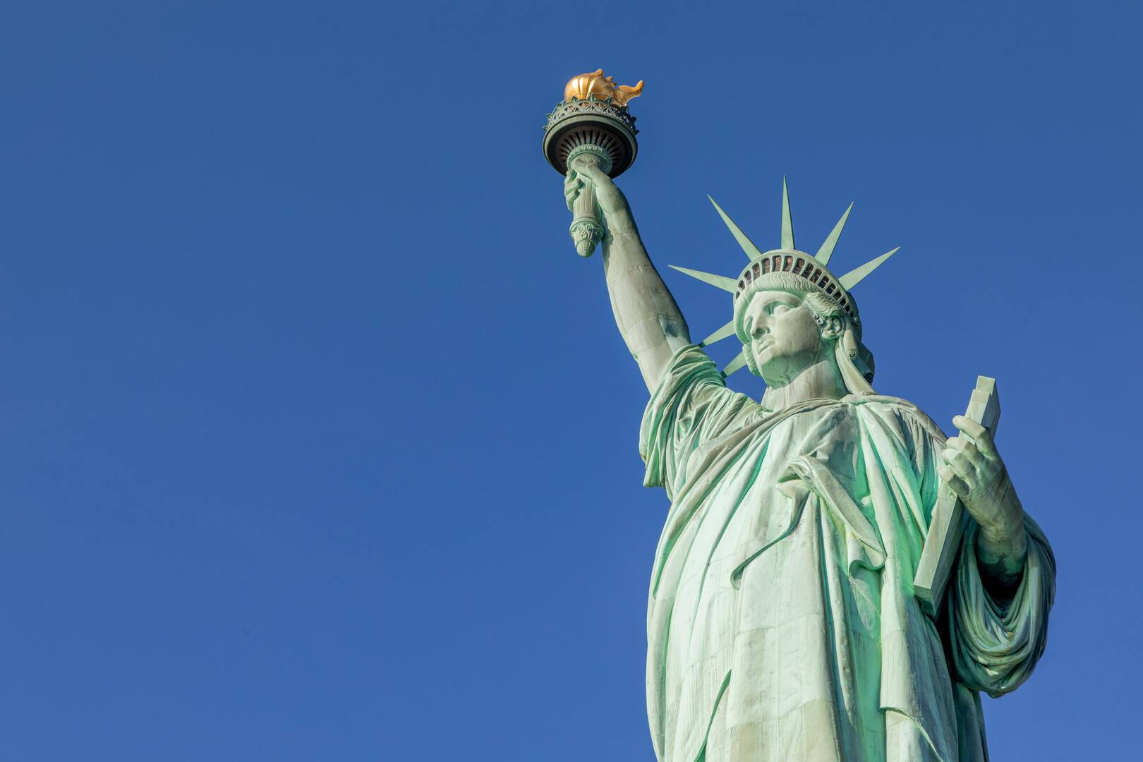 Liberty Island aerial view with Statue of Liberty and Manhattan skyline